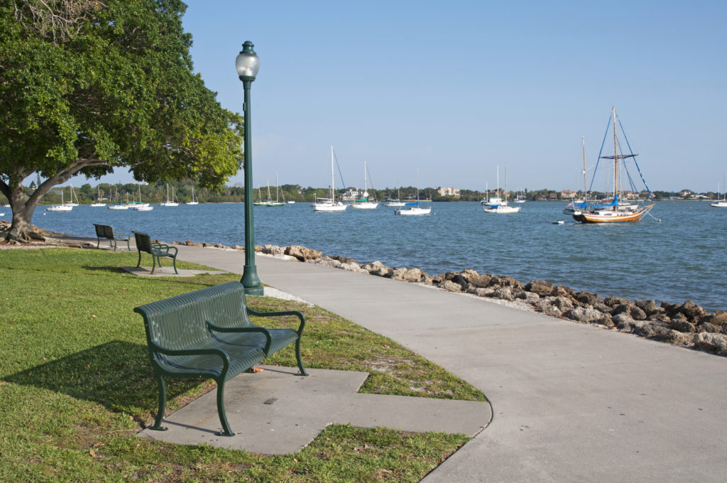 park bench on a waterfront full of sailboats