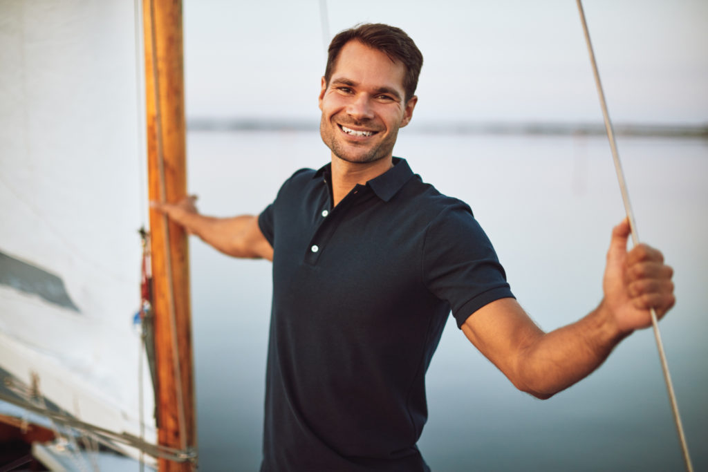 smiling man on a sailboat